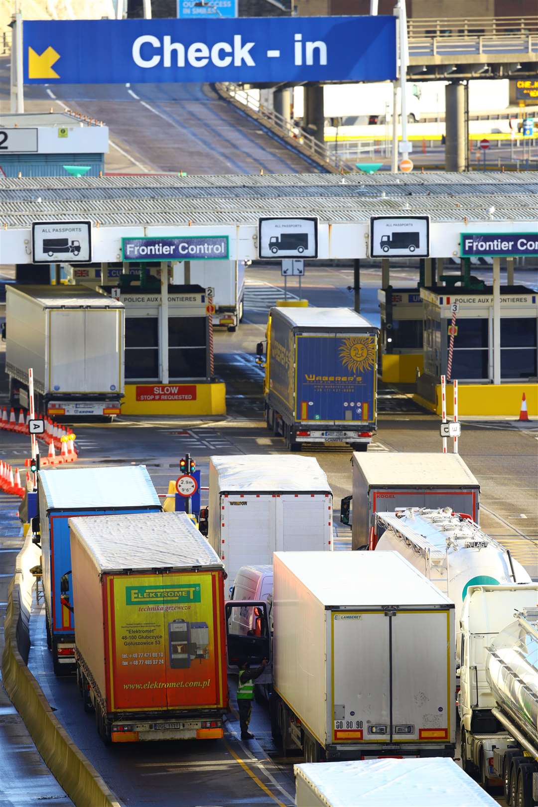 Freight lorries pass through the check-in area at the Port of Dover, where thousands are waiting to resume their journey across the Channel (Aaron Chown/PA)