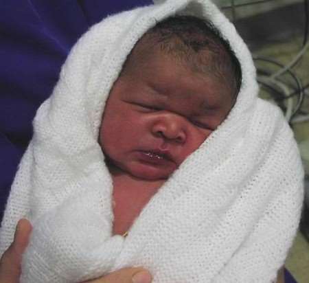 IN SAFE HANDS: the baby girl pictured in hospital