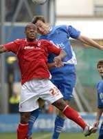 Gillingham's Mark Bentley challenges wth Junior Agogo in the air. Picture: GRANT FALVEY