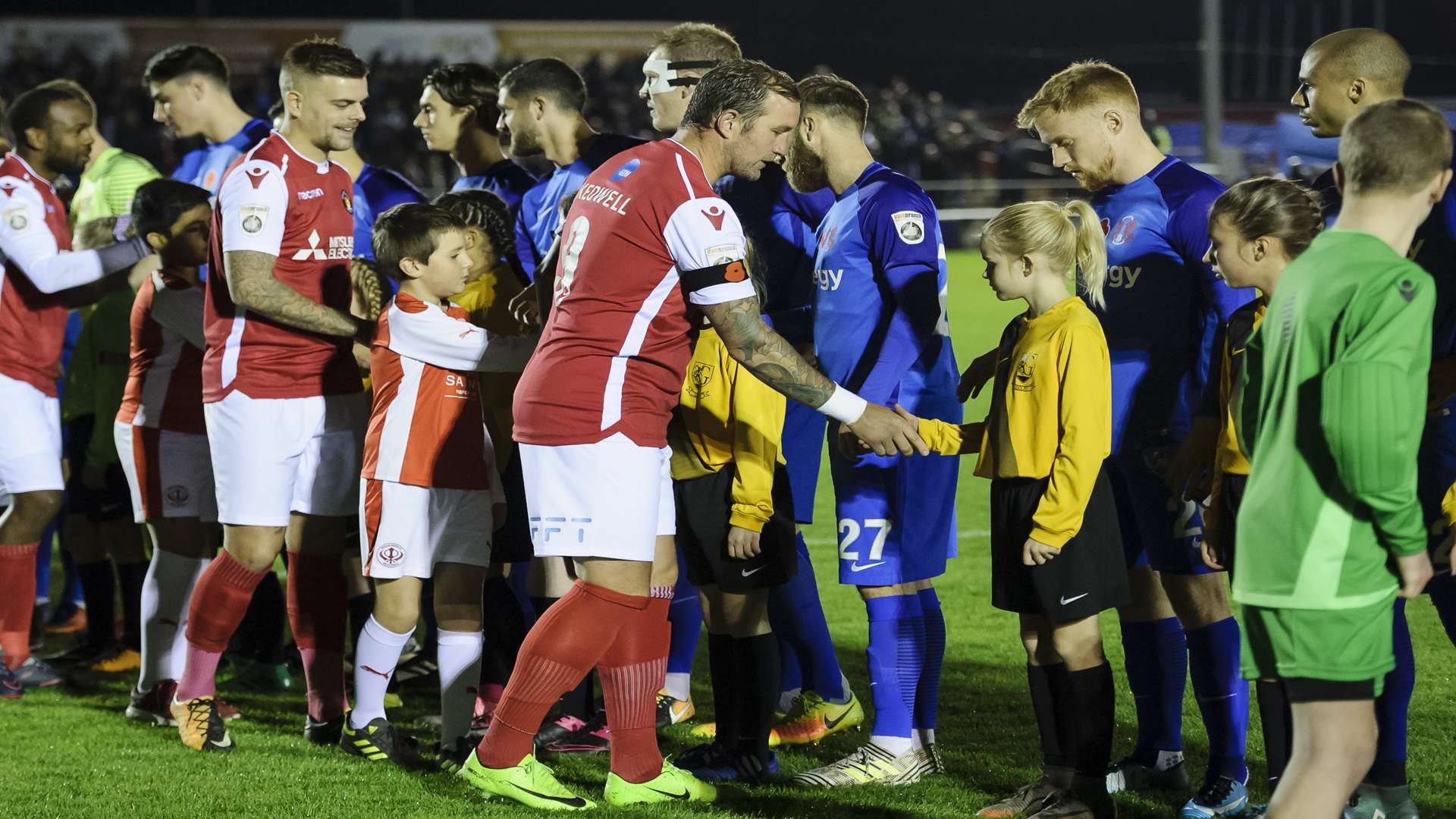Skipper Danny Kedwell leads Fleet in the pre-match handshake Picture: Andy Payton