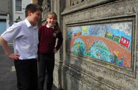 George 10 and Laila 11 with a mosaic of a train on Holy Trinity and St John's School. Picture: Barry Dunfield