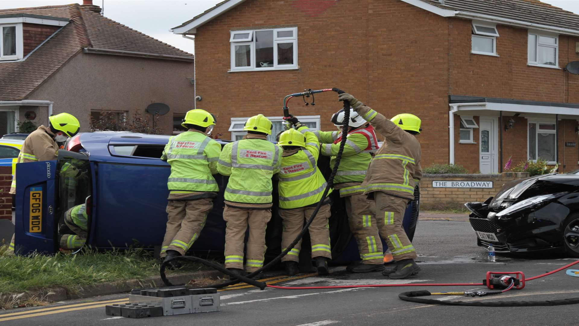 Firefighters removing the roof off one of the cars involved. Pictures: Geoff Gambrill
