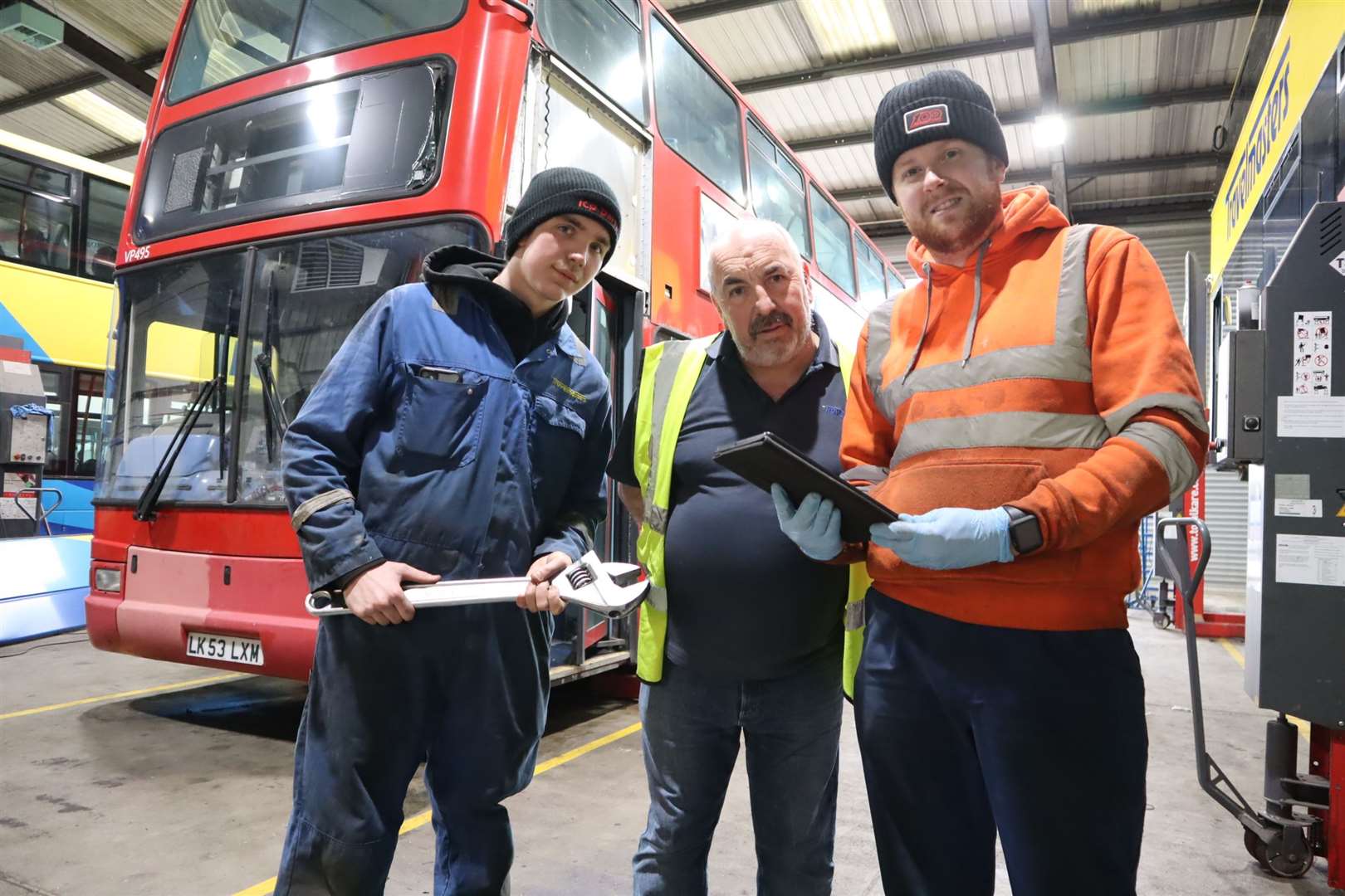 Tim Lambkin, centre, of Travel Masters with apprentices Tim Lambkin and James Chisman. The company donated a former London double-decker for the Sheppey Support Bus project