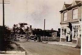 The Sheppey Light Railway crossing at Minster Road by the shops opposite the Harps Inn