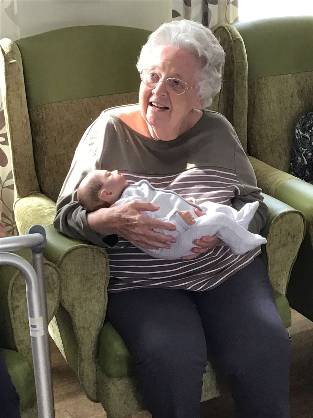 Jean, a resident at the home, looks after the baby. Picture: Rapport Housing & Care