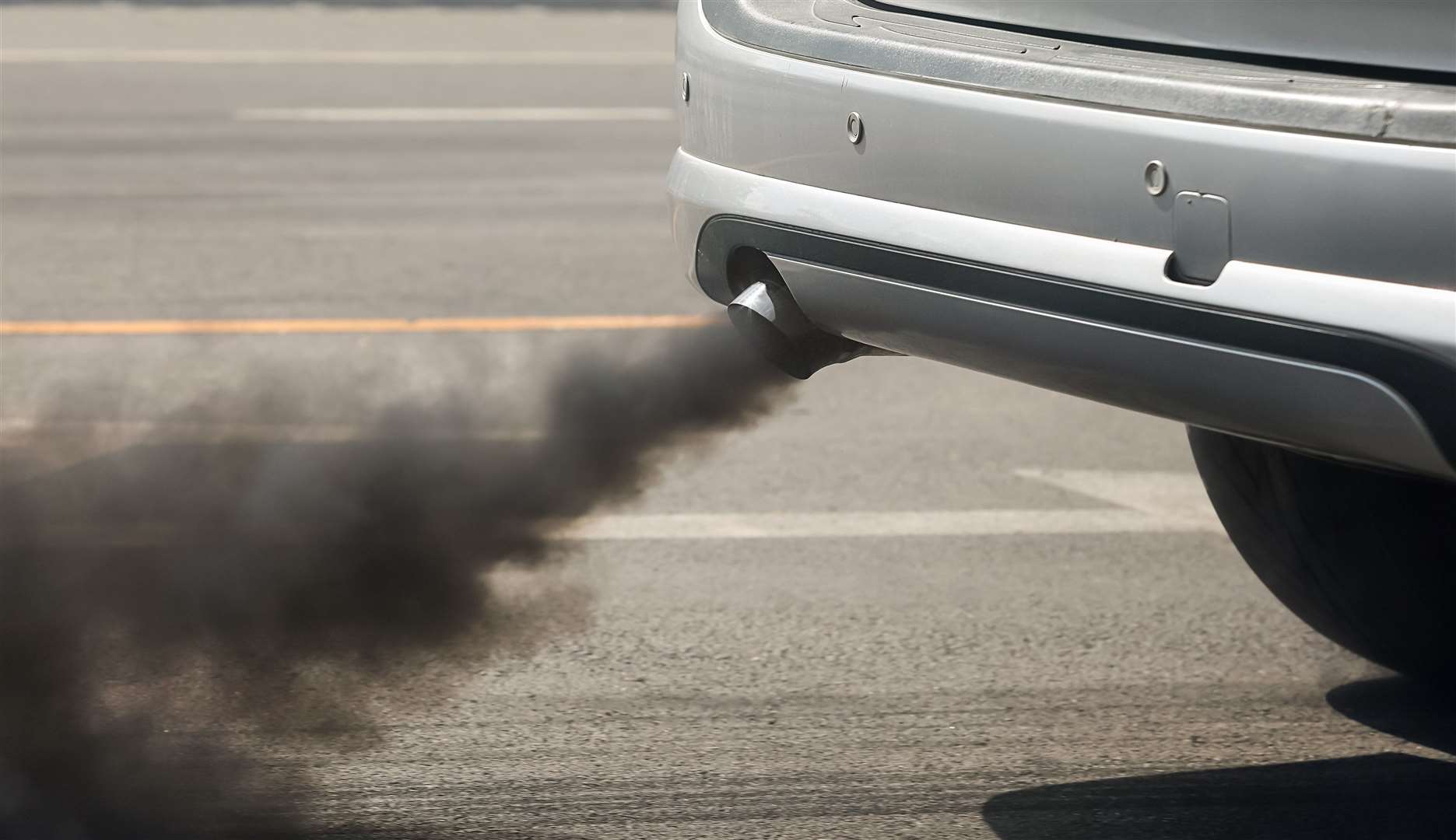 Air pollution from vehicle exhaust pipe on road. Stock image: iStock