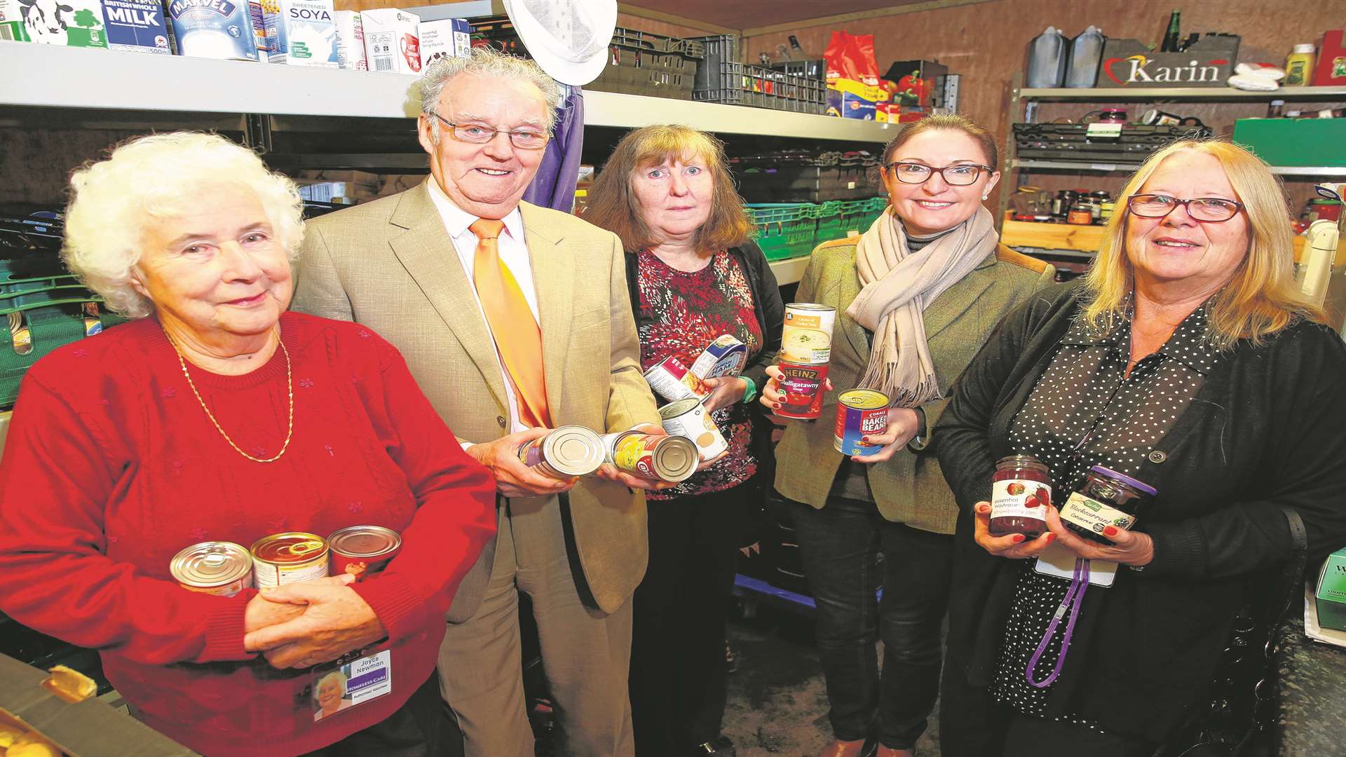 Trustees and volunteers Joyce Newman, Mike FitzGerald, Kathy High, Lisa Delaney and Sue Wood with tins of food at n Maidstone Day Centre, Knightrider Street. Picture: Matthew Walker