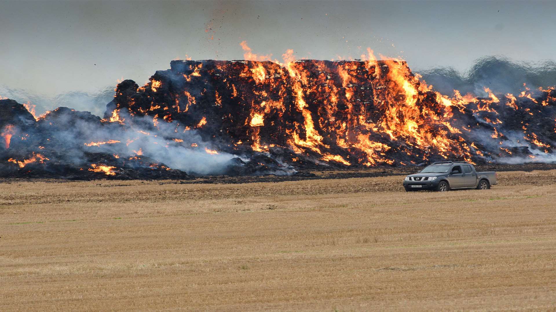 Stock Image: A large haystack ignited in flames in a field in Eythorne two years ago