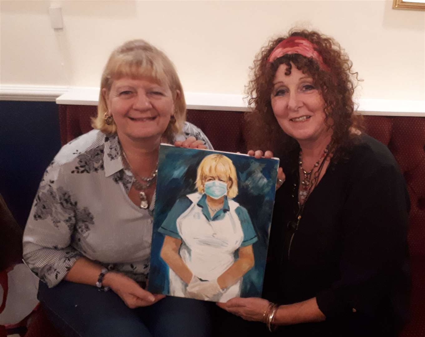 Carol Kimber of Maidstone is presented with her portrait by friend and Sheppey artist Julie Bradshaw-Drury