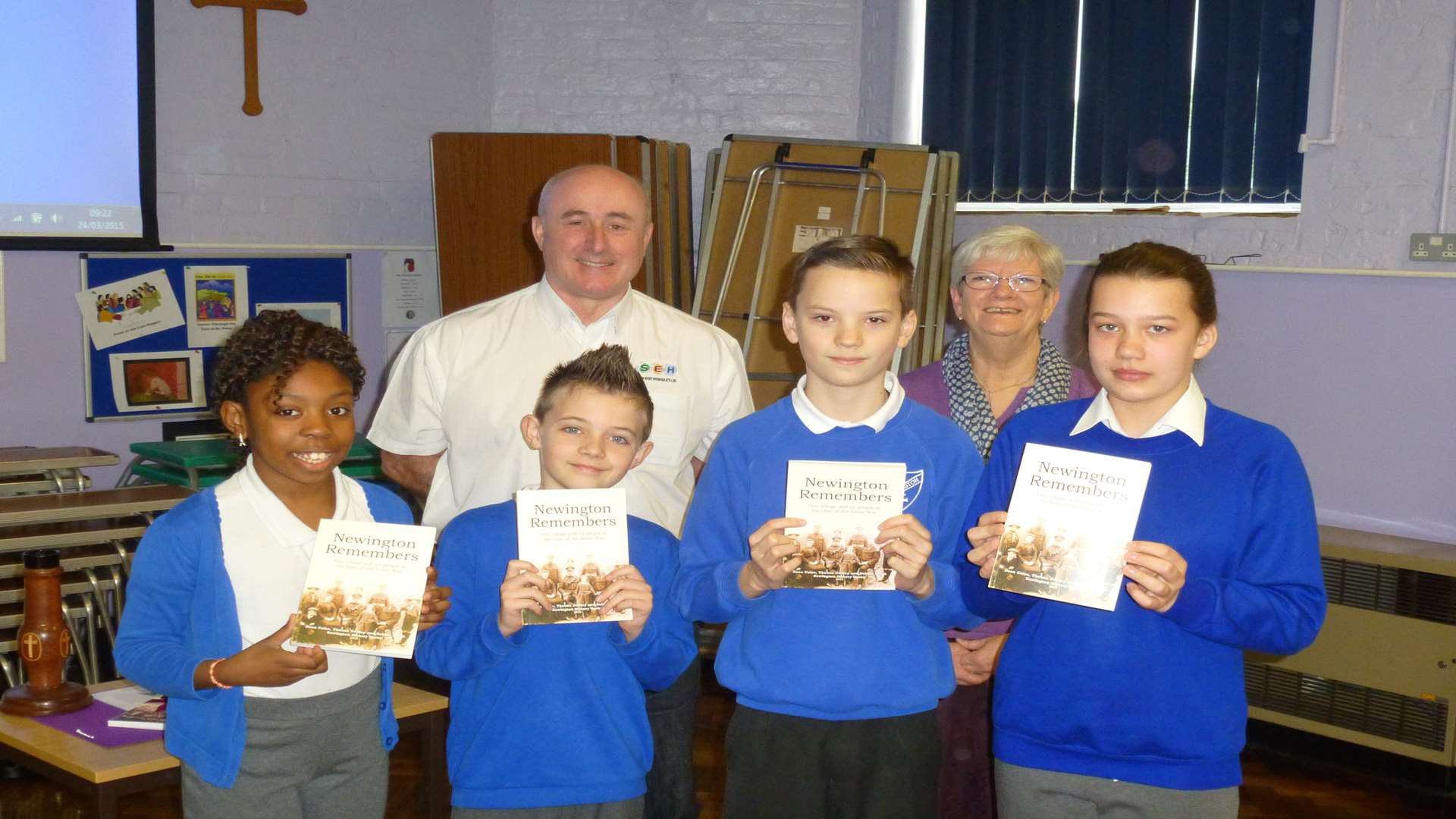 Grace, Owen, James and Rosina, members of Newington Primary school council, receive the books from authors, Dean Coles and Thelma Dudley