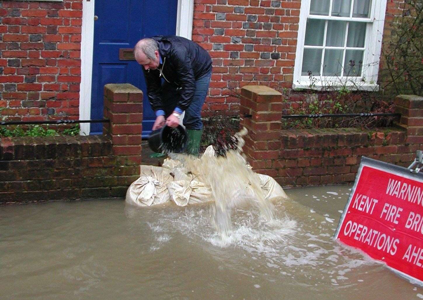 Homeowners used buckets to try and bail the flood water away from their homes in Canterbury