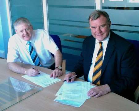 Canterbury Rugby Club's new sponsor David Thompson (left) of Marine Travel Company puts pen to paper on the deal with club official John Pratt.