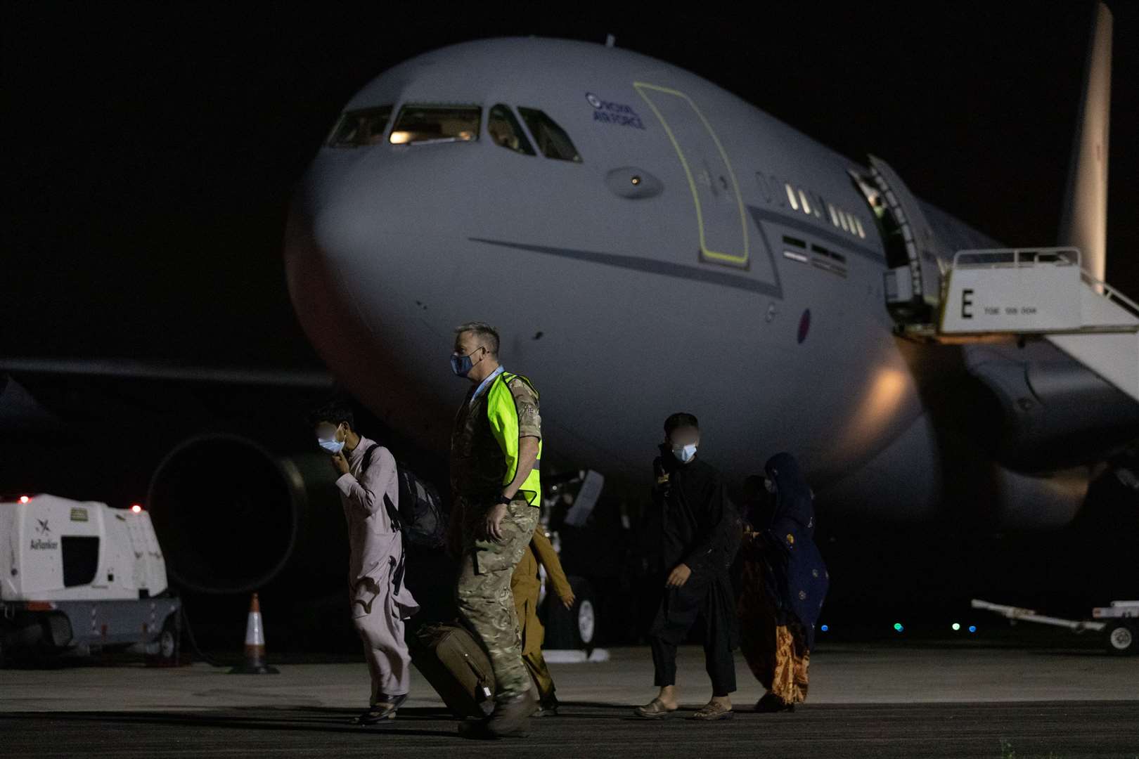 RAF Brize Norton personnel escorting passengers last Thursday from a RAF Voyager aircraft bringing refugees from Afghanistan. Picture: UK MOD