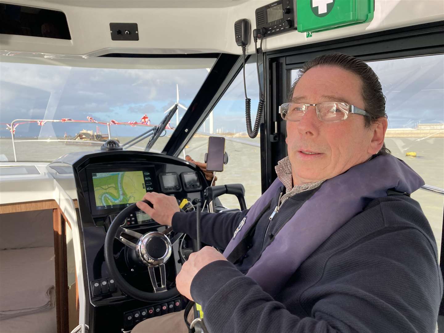 Adam Ervin, owner of the Queen Phillippa guest house at Queenborough at the wheel of his £185k Merry Phillippa yacht