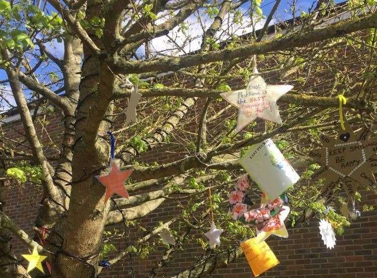Children have decorated a tree opposite the Methodist Church with uplifting messages