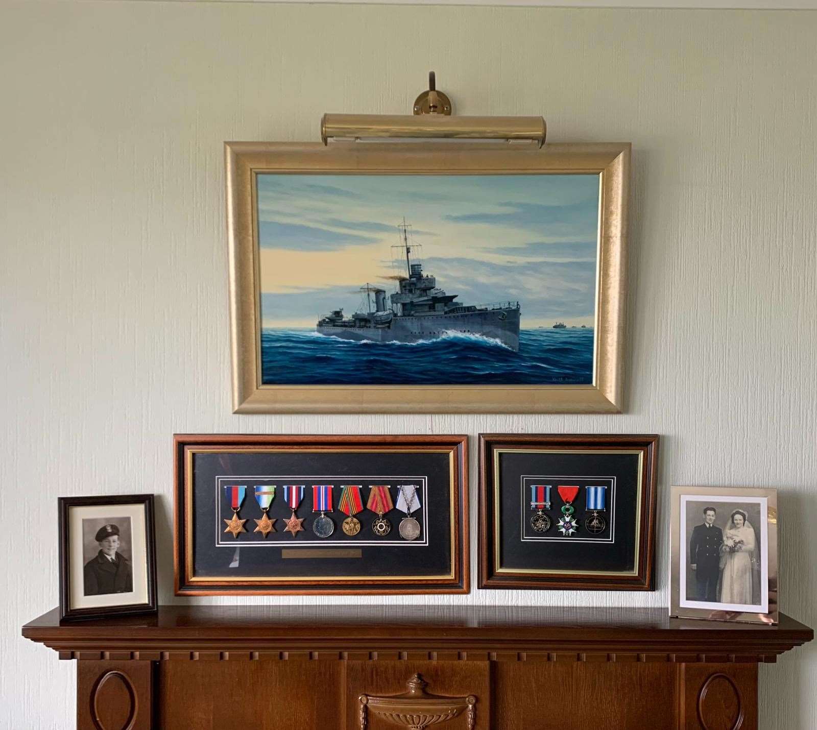 Cyril keeps his medals on display along with pictures pictures and a painting of a Royal Navy destroyer