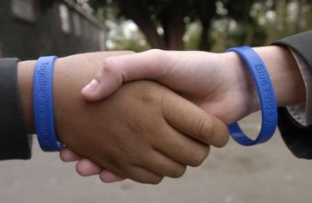 Schools are tackling racism, with initiatives such as blue anti-bullying bands