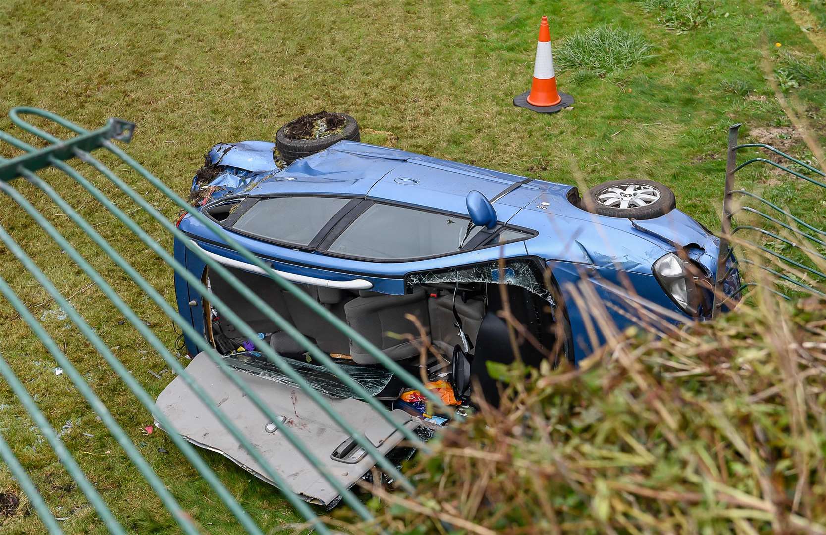 The car on its side with the roof removed to free the driver. Picture: Alan Langley