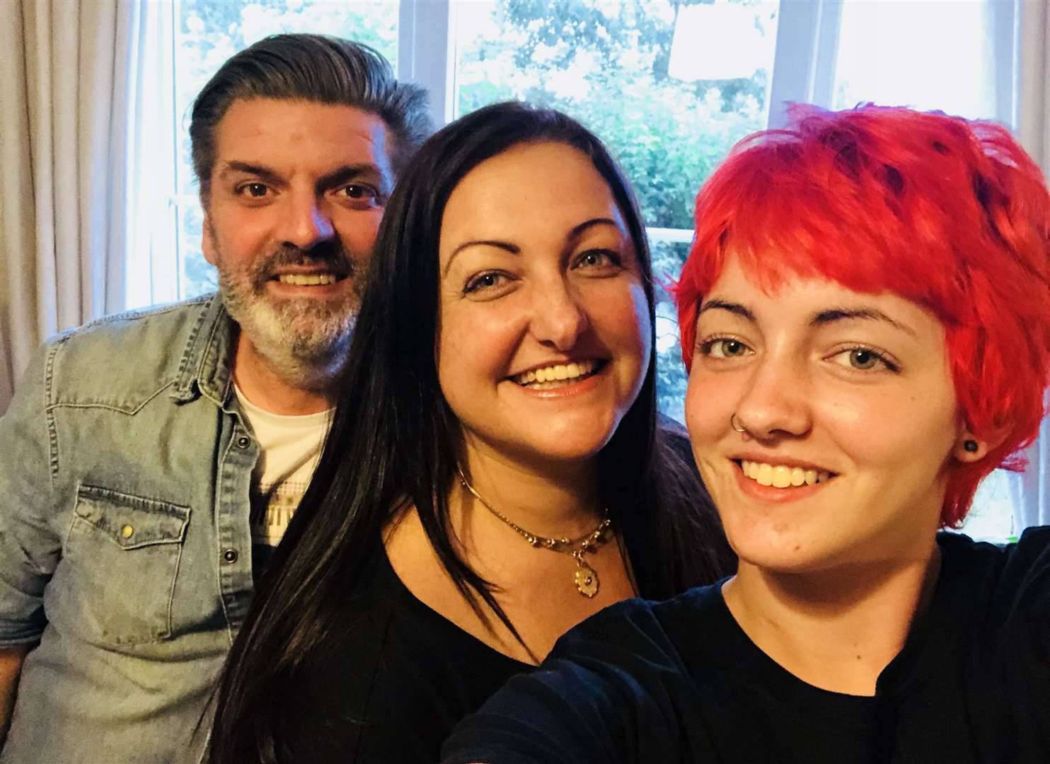 The teenager was all smiles with her mother and father one year after the ordeal