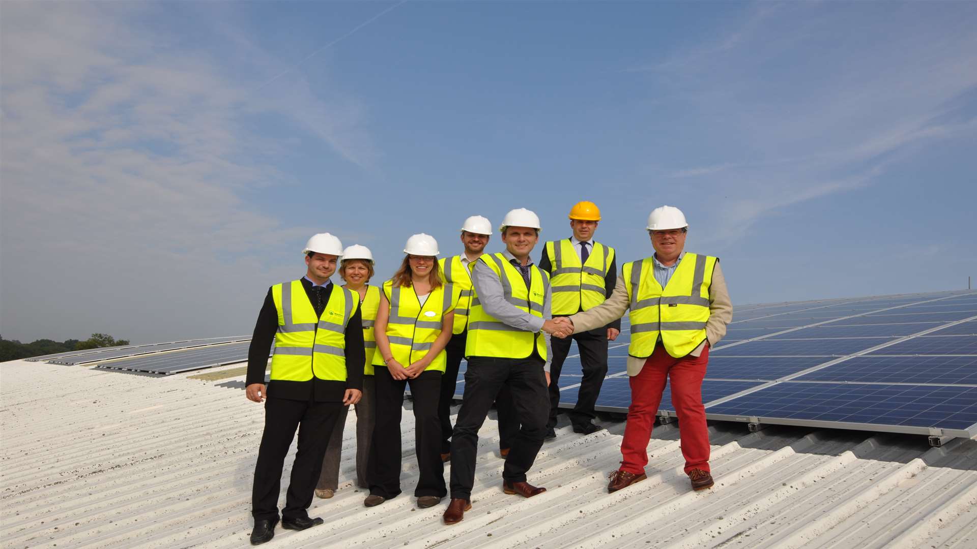 Representatives from TWBC, Ecosphere Renewables and Fusion Lifestyle on the tennis centre roof with the solar panels