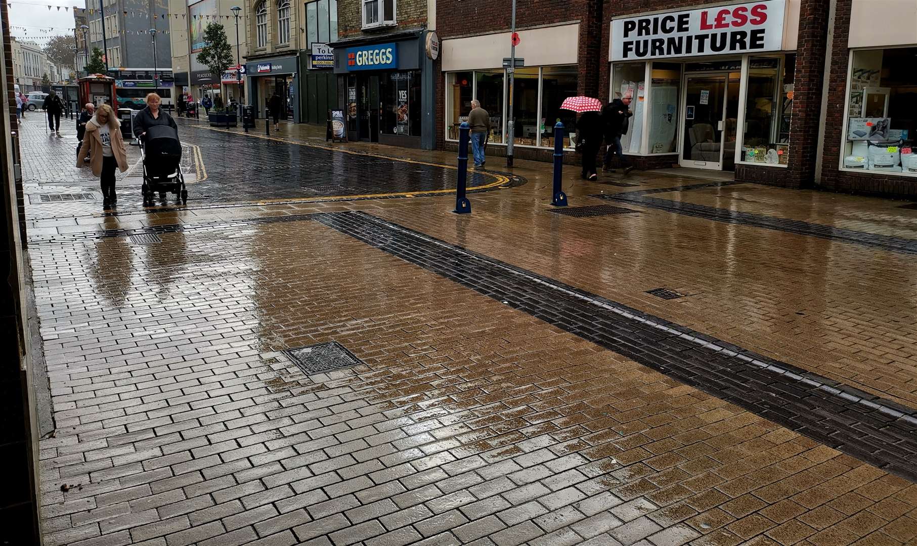 People rushed from shop to shop in the poor weather