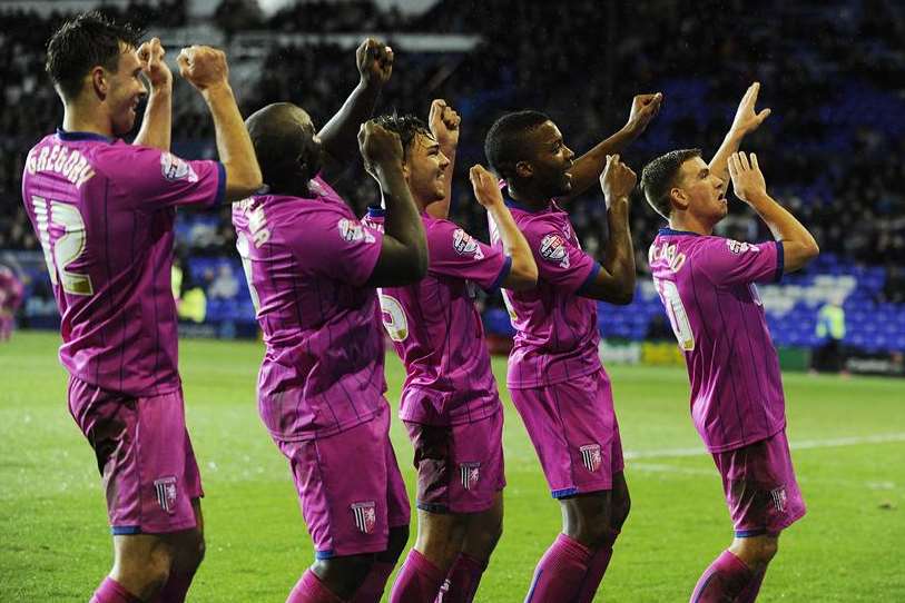Gillingham striker Adebayo Akinfenwa, second left, and his team-mates celebrate their second goal at Tranmere. Picture: Barry Goodwin