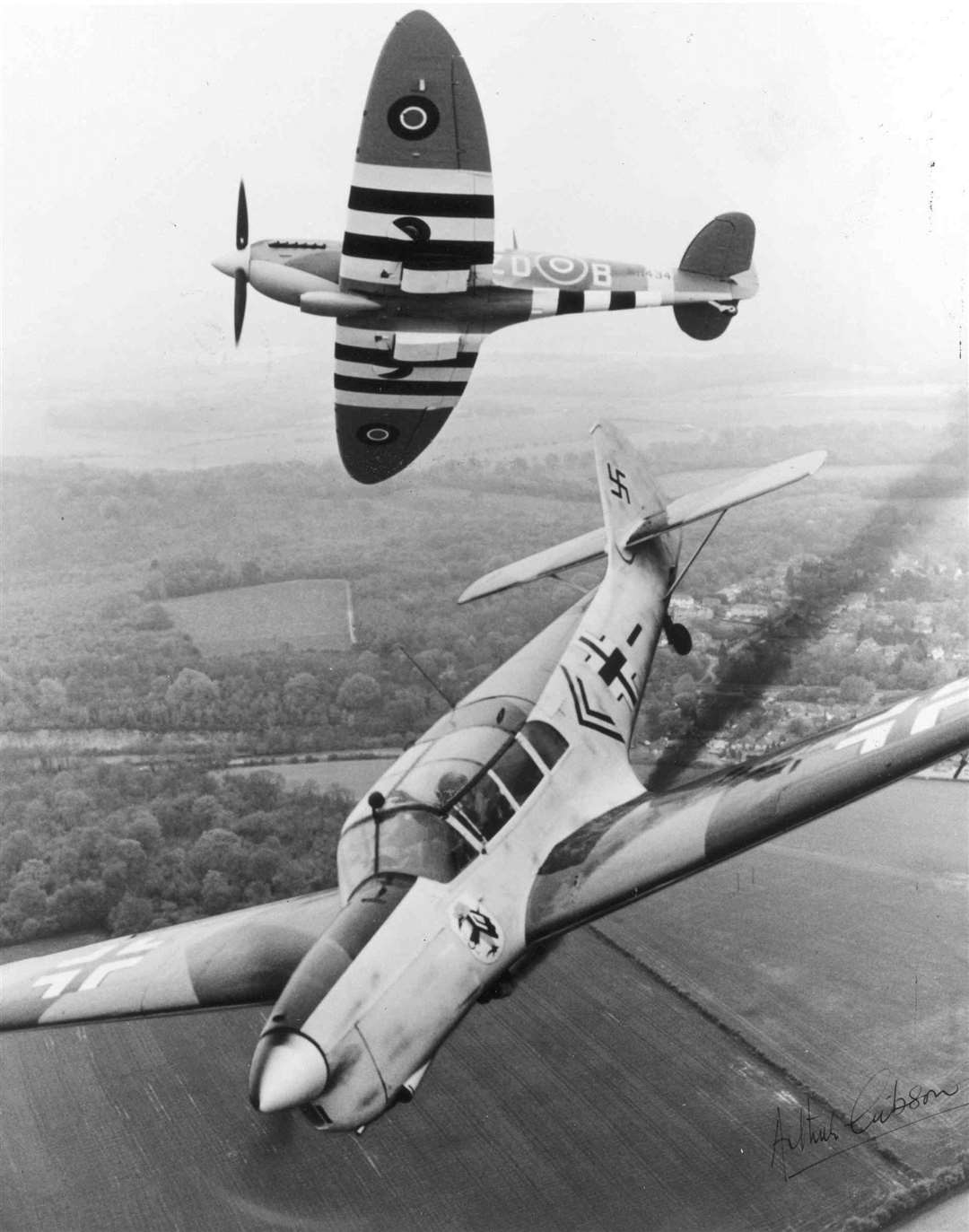 A spitfire 'shoots down' a Messerschmidt 108 over the airfield boundary, a scene reminiscent of many that took place over the Kent Countryside during the war years. August, 1985