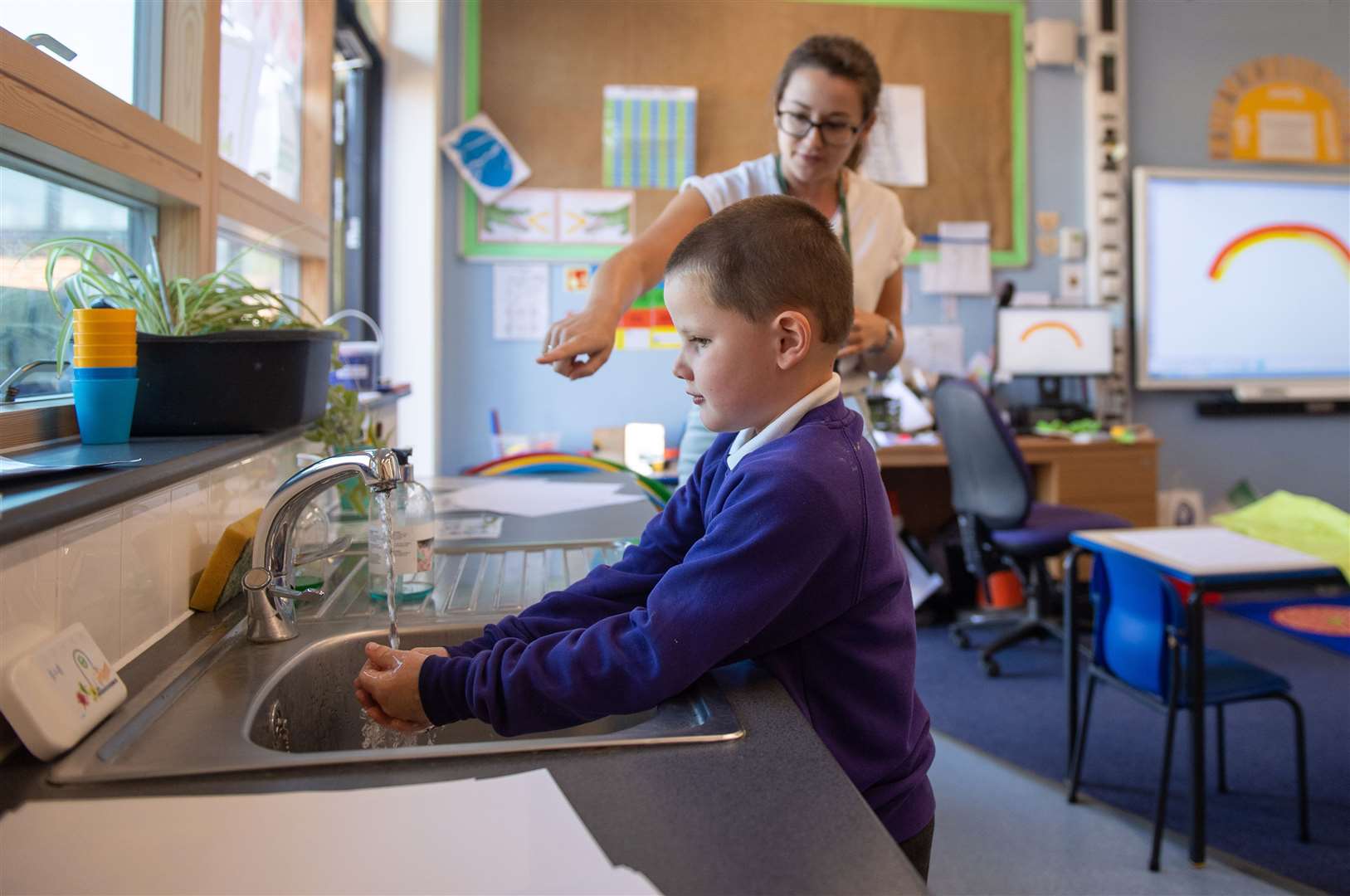 Reception pupil Braydon washes his hands whilst watching an electronic timer (Joe Giddens/PA)
