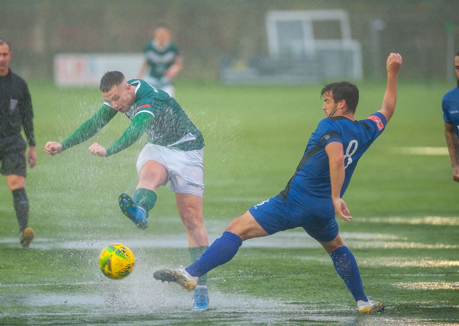 Ashford United midfielder Josh Wisson tries to make the best of difficult conditions against The Bridges Picture: Ian Scammell