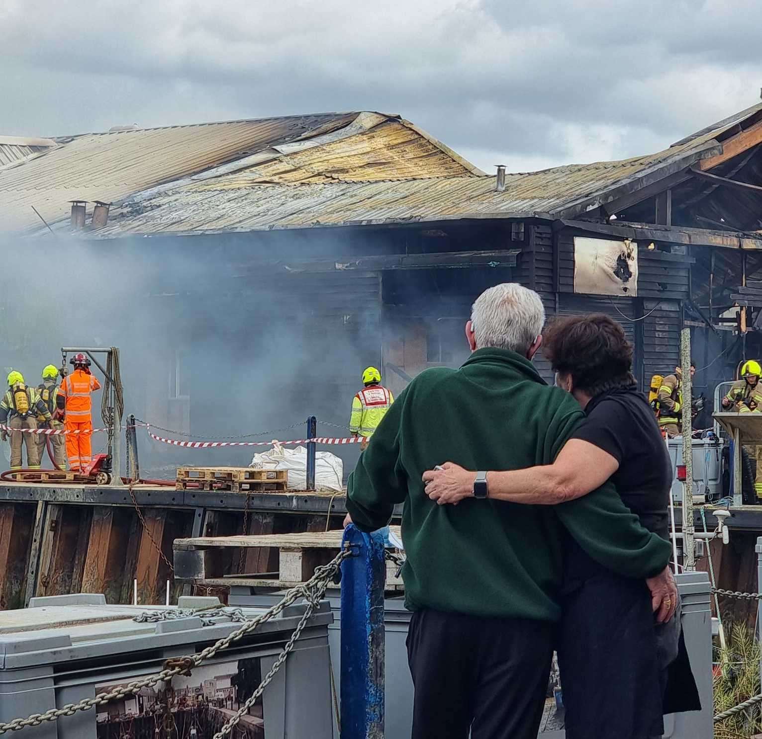 Crab and Winkle Restaurant owners Peter and Elizabeth Bennett as they watch the fire at the cockle shed in Whitstable harbour engulf their business. Picture: Charlotte Rose Nash