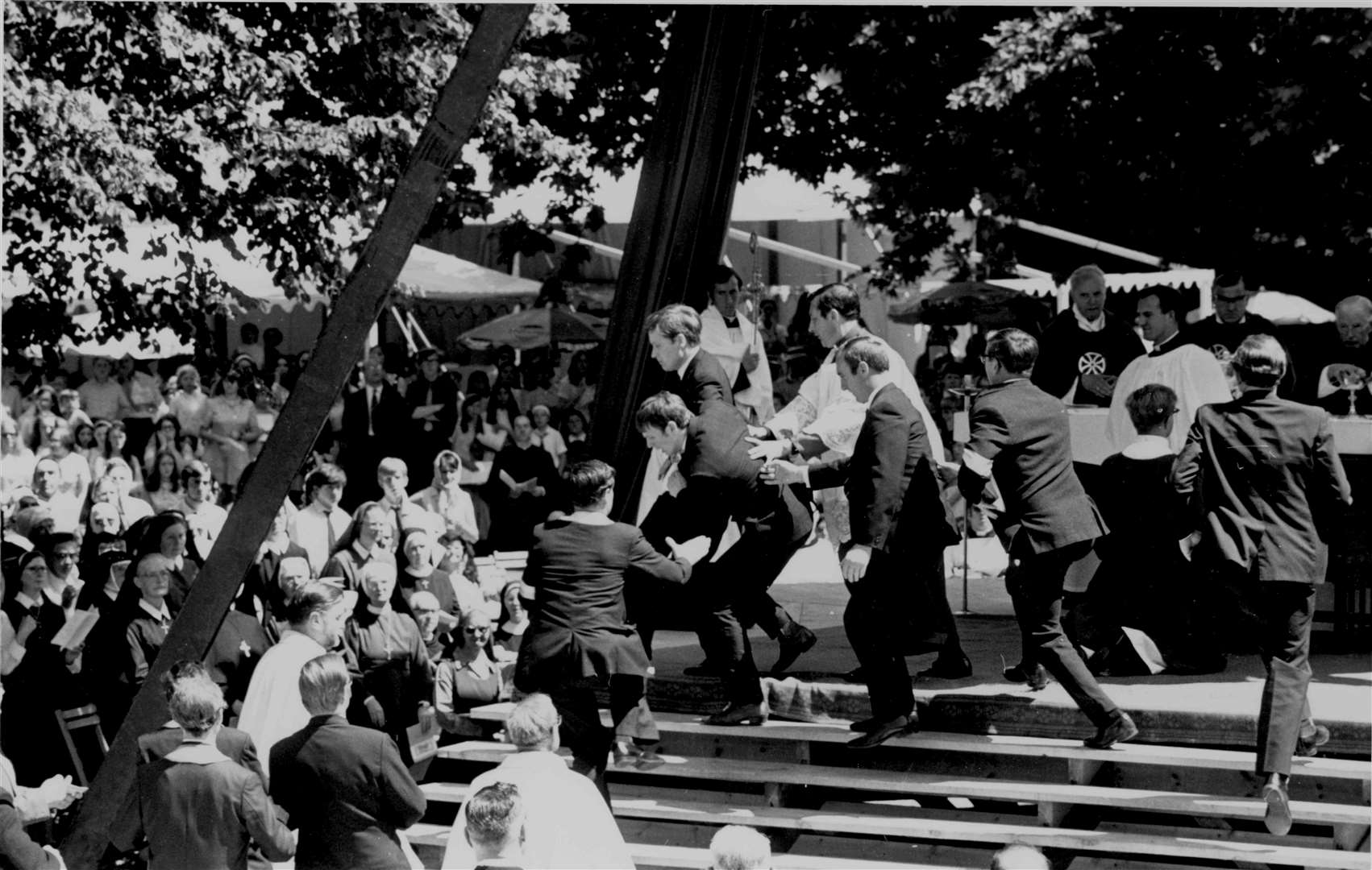 Thousands of pilgrims in the Precincts of Canterbury Cathedral watched police grapple with two militant Protestants who rushed the altar during a Roman Catholic mass in July 1970. The mass was the first to be celebrated in the Precincts for 400 years and was held as part of the Cathedral's programme to commemorate the 800th anniversary of the murder of Thomas Becket