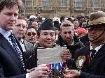 Lib Dem leader Nick Clegg collects long-service medals at the Gurkha protest