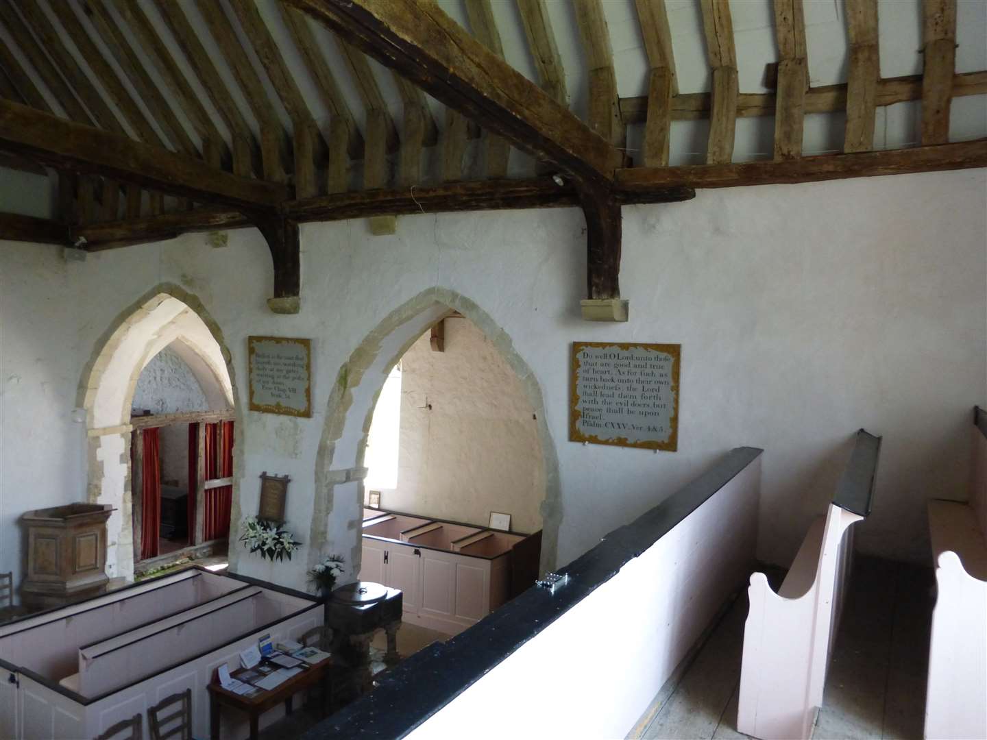 The pink-painted gallery and box pews at Old Romney Church can still be viewed today