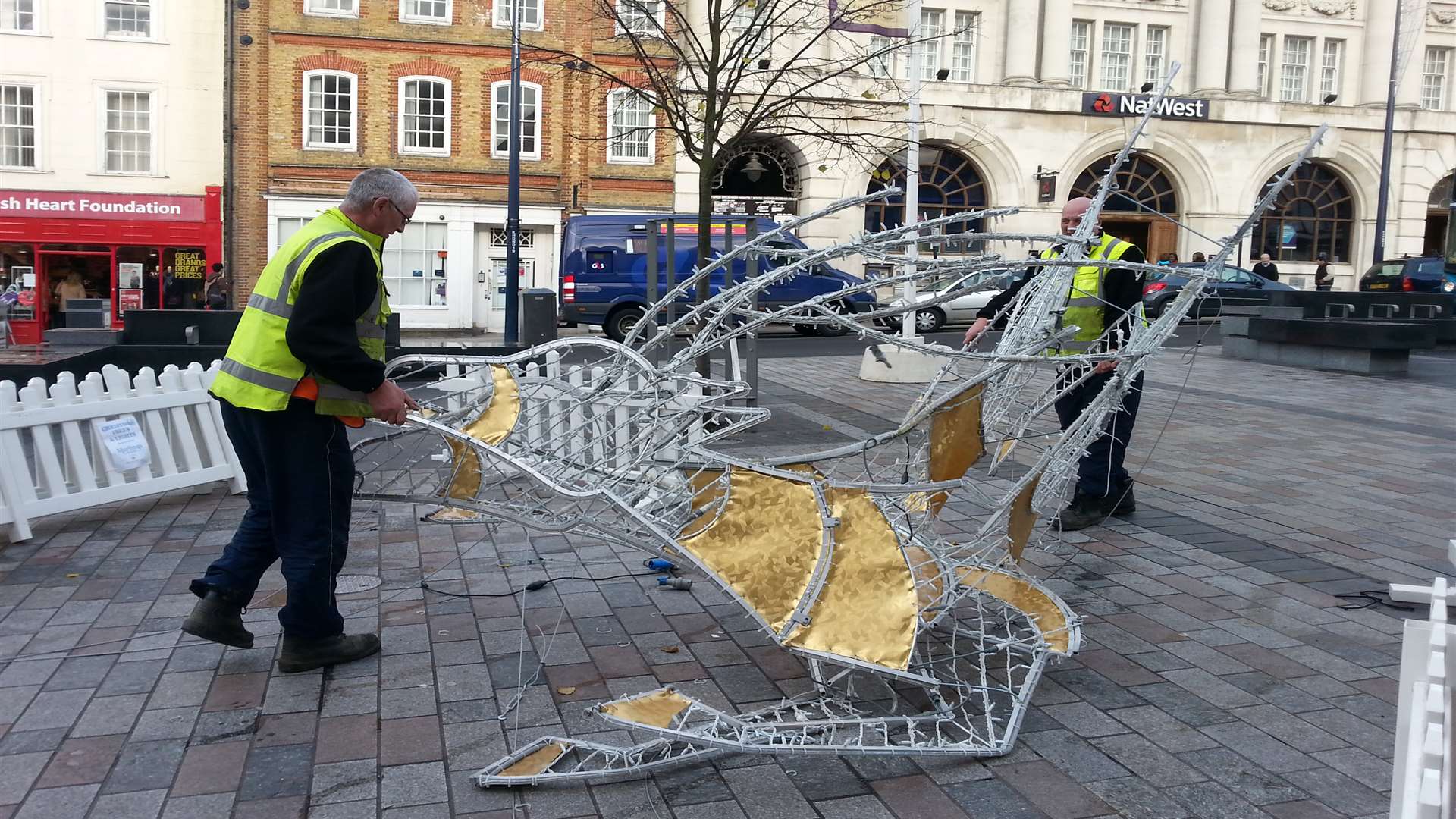 The damaged reindeer is loaded onto a van