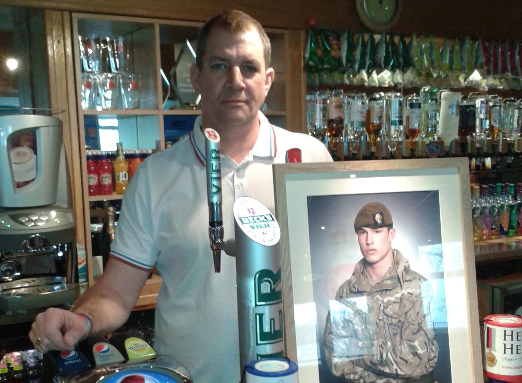 Duane Ashworth with a picture of his son, L/Cpl James Ashworth, who was awarded the Victoria Cross.