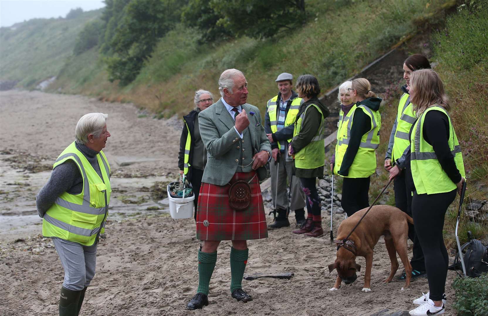 Charles on the beach with volunteers (Paul Campbell/PA)