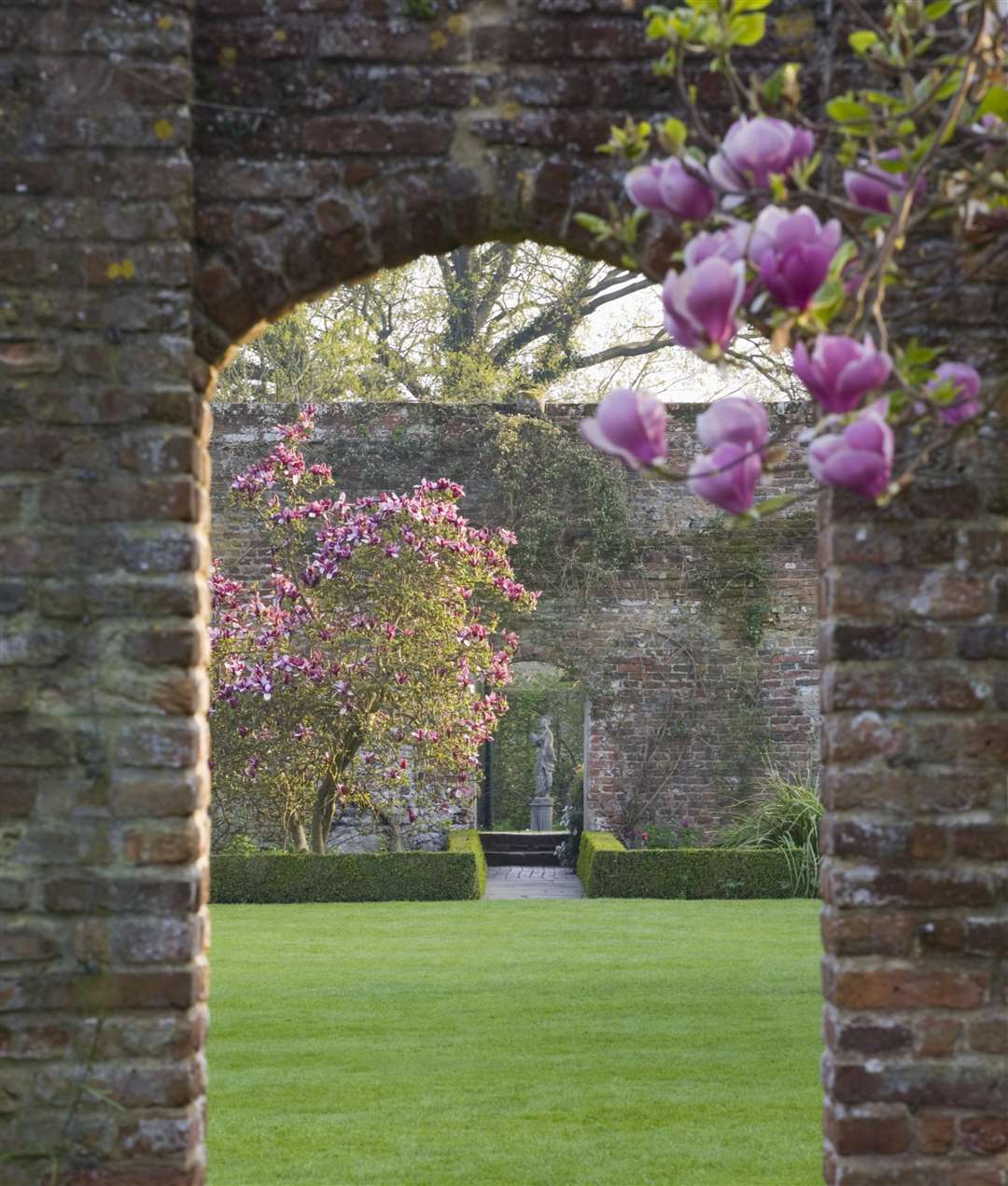 An arch from the White Garden over the Tower Lawn leads to the Rose Garden at Sissinghurst Castle Garden Picture: National Trust