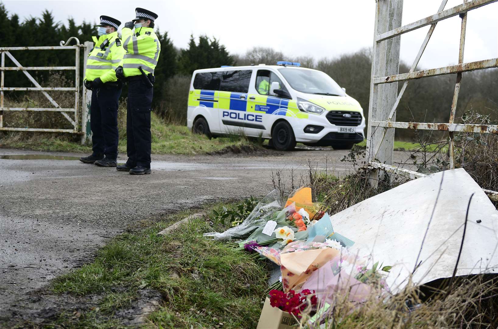 Flowers left by the public at the entrance to the search site in Great Chart. Picture: Barry Goodwin