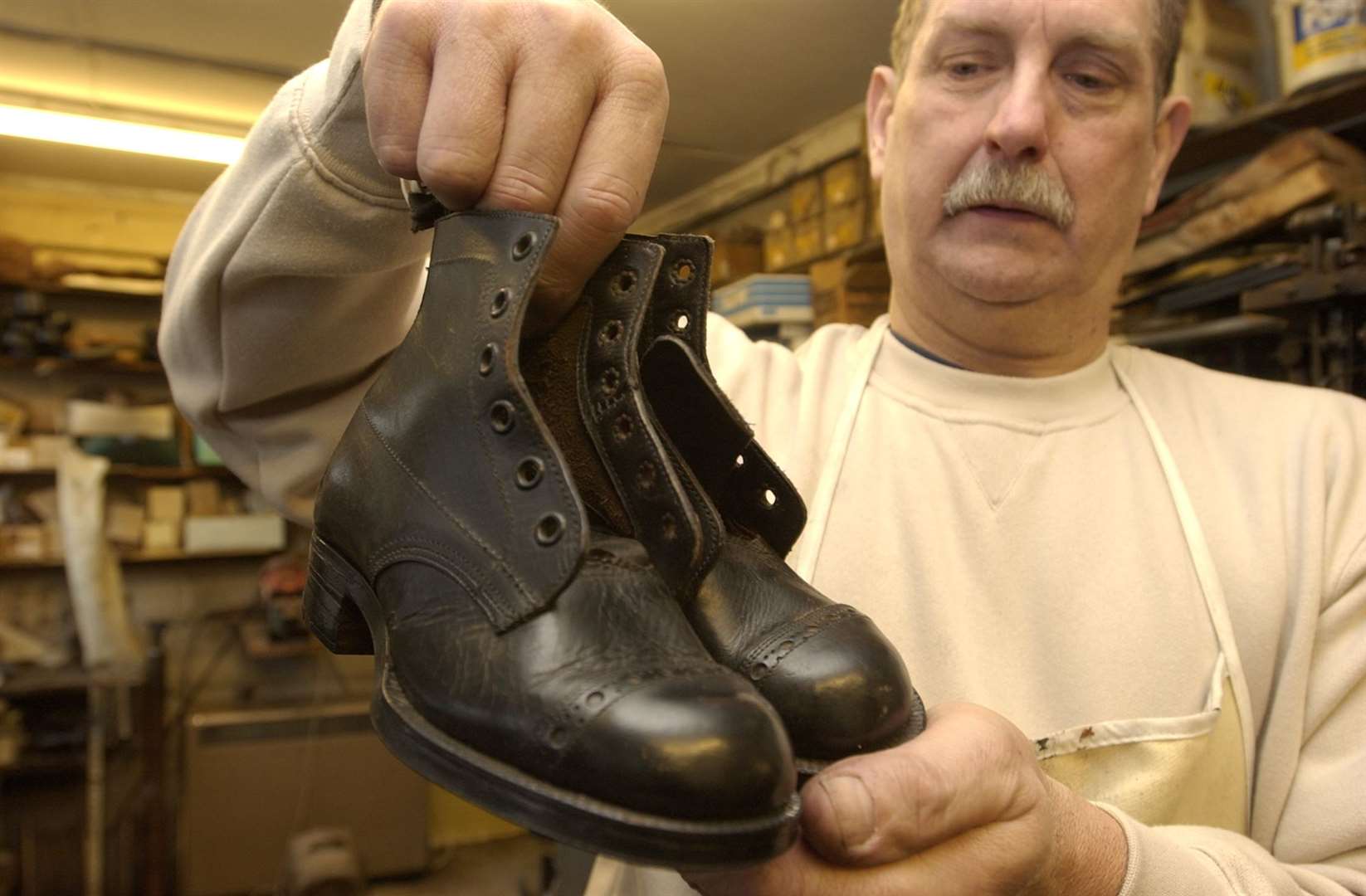 Peter Earl with boys' school shoes from 1930s in February 2004