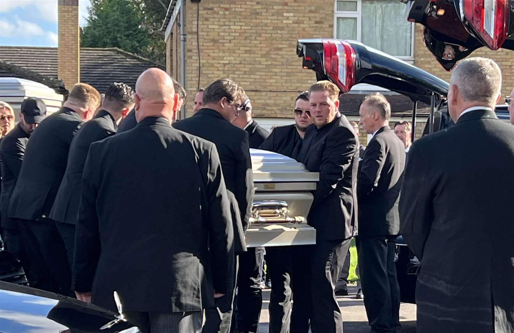 One of the coffins is carried into a hearse. Picture: Barry Goodwin