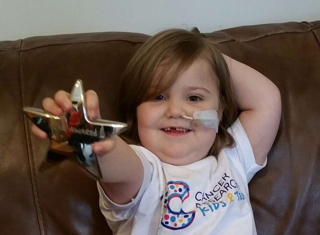 Sabine White, four, with her bravery award from Cancer Research UK