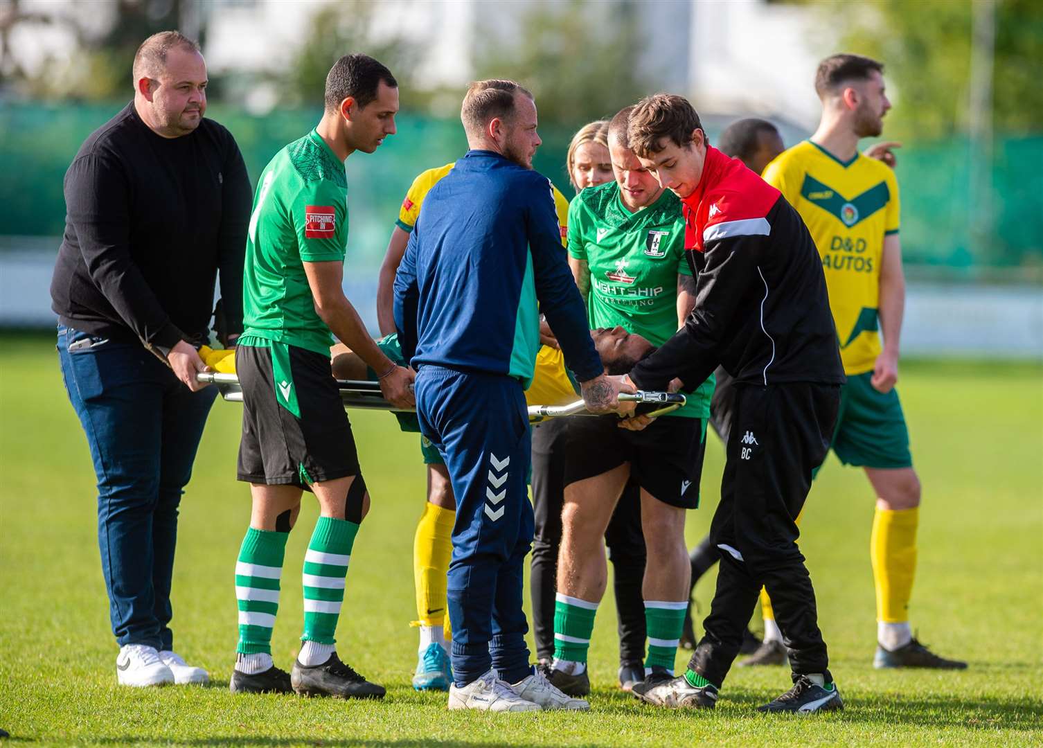 Ashford United full-back Tariq Ossai is carried off after suffering a shoulder injury after just 15 seconds Picture: Ian Scammell