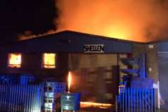 Flames take hold at the unit. Picture @kentfirerescue