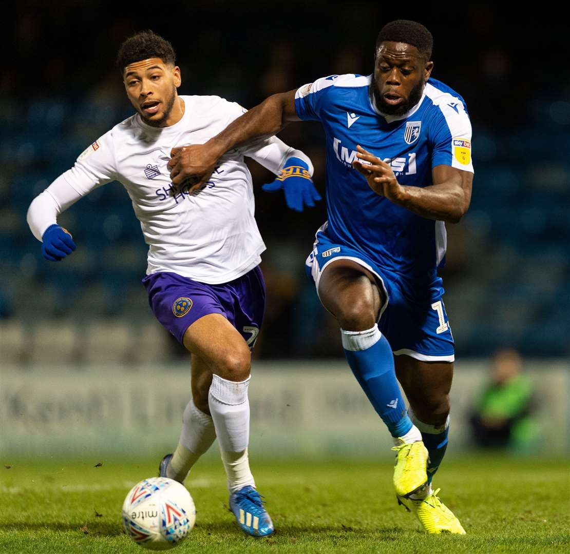John Akinde gets to the ball ahead of Shrewsbury's Josh Laurent Picture: Ady Kerry