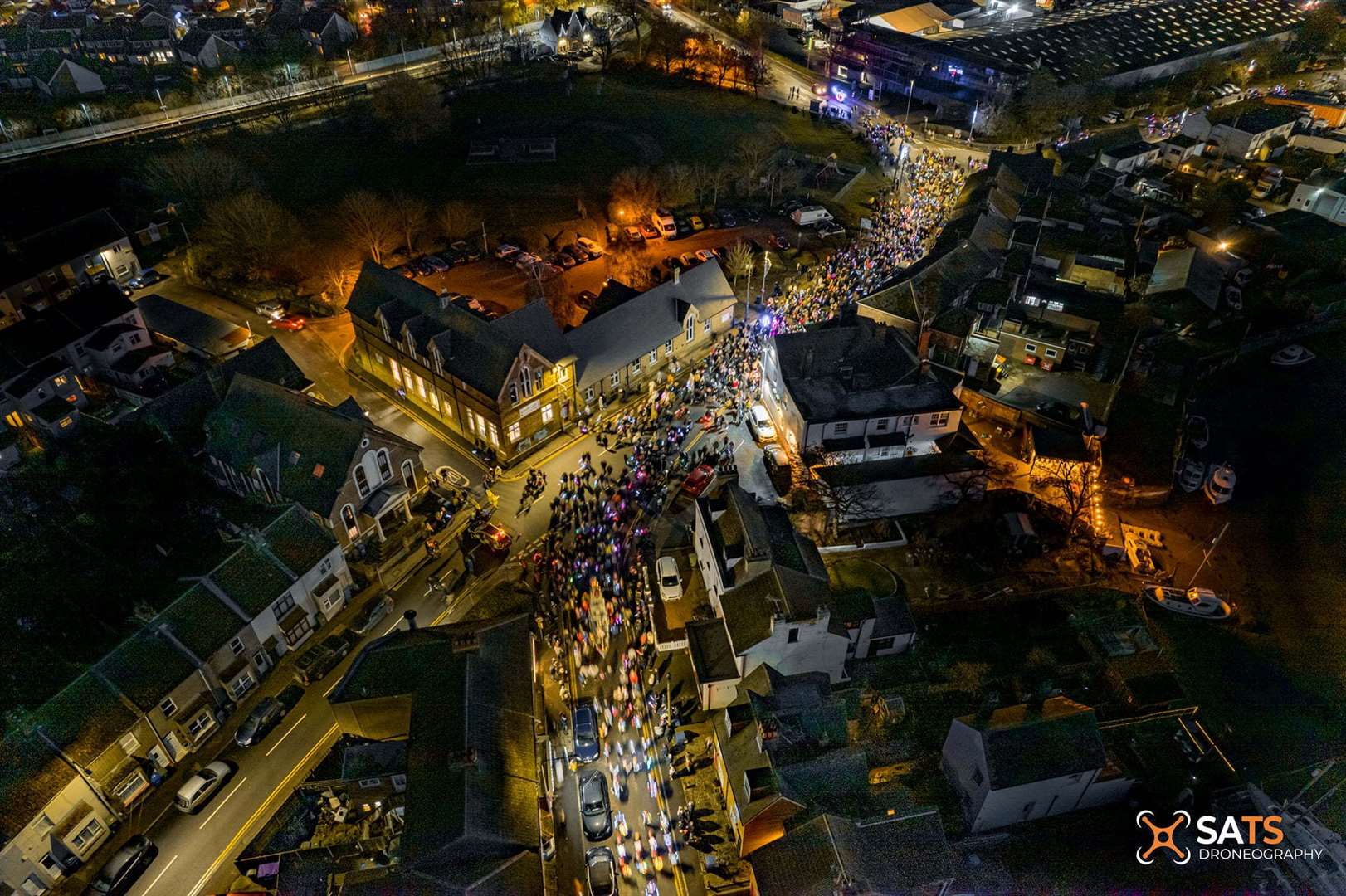 Hundreds of people can be seen from the air flocking to Queenborough for the lantern parade. Picture: SATS Droneography