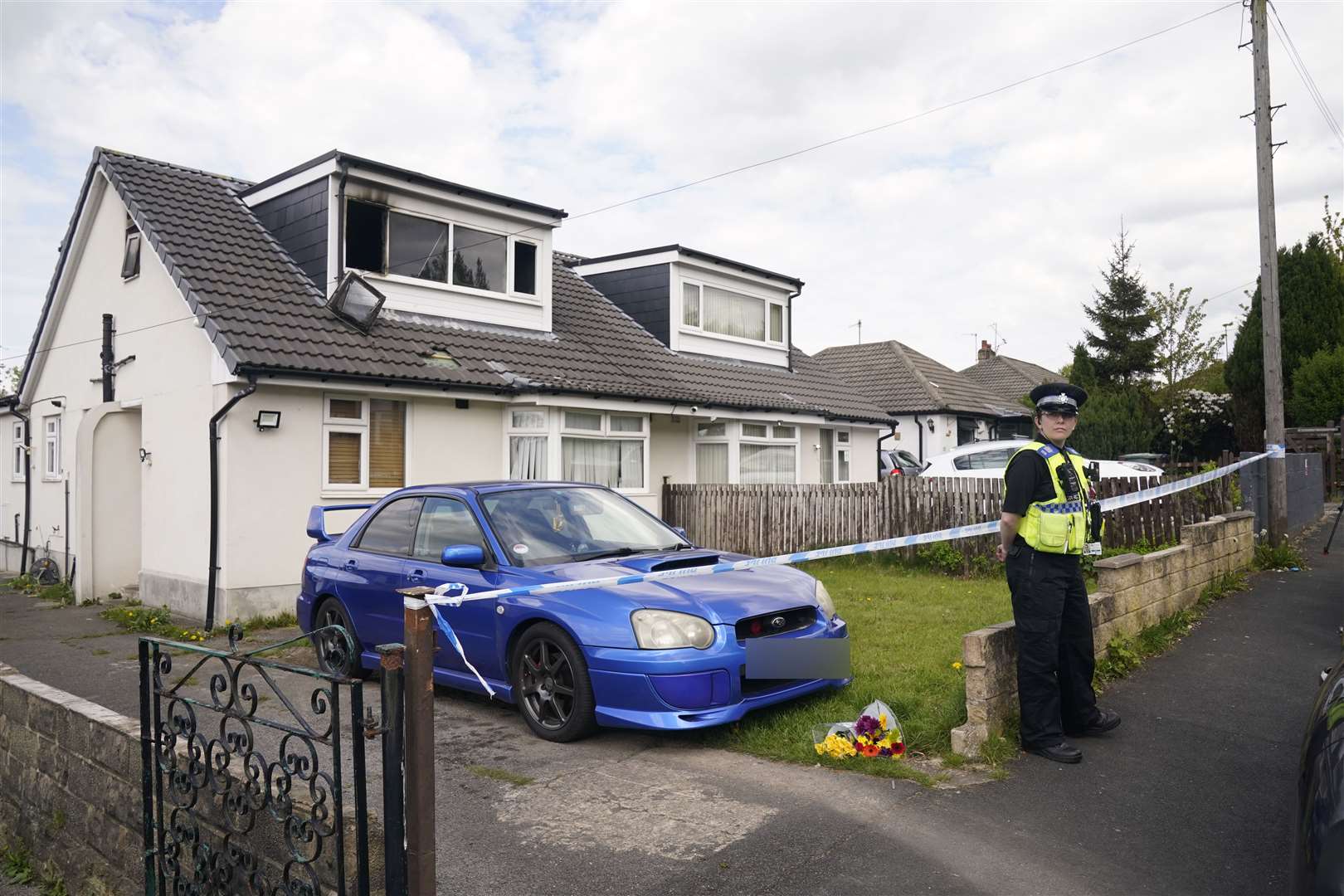 A police officer at the scene of the fatal house fire in Bradford (Danny Lawson/PA)