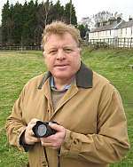 Cllr Nigel Whitburn chairman of Ash Parish Action Plan Steering Group, taking snaps of village