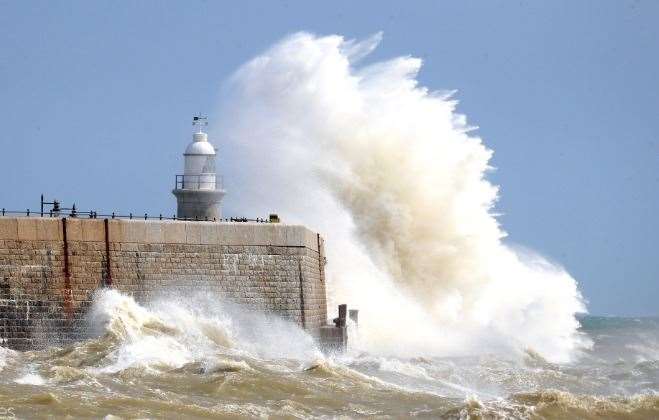 Waves crash over the harbour wall in Folkestone, Kent. Photo: Gareth Fuller/PA Images