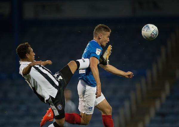 Gillingham’s Aaron Simpson challenges with Portsmouth’s David Wheeler Picture: Ady Kerry