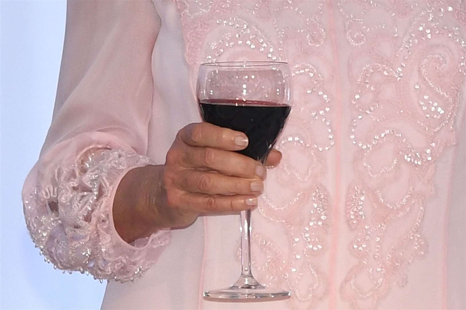 A person holding a glass of wine (Joe Giddens/PA)